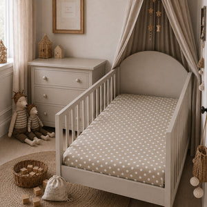 Beige polka dot baby fitted sheet on a white cot, made from 100% OEKO-TEX® cotton in the UK, Fabricco