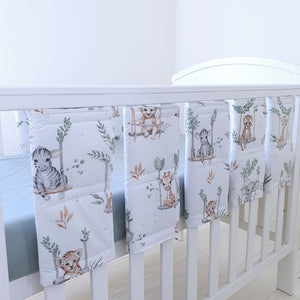Sage green cot bed wraps with jungle animal prints, made from soft cotton with adjustable Velcro fastenings for a secure and breathable fit.