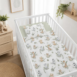 Cute Jungle Animals safari baby bedding set for cot bed, styled in a neutral Scandinavian nursery with wooden cot, sage decor and soft jungle animal print. Fabricco UK baby shop
