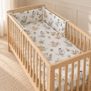 Cute Jungle Friends bumper fitted around a 60 × 120 cm oak cot in a Scandinavian nursery.
