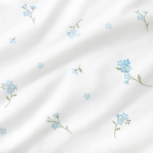 Blue forget-me-not floral 100% cotton fabric with green leaves on a white background, OEKO-TEX certified fabric by the metre UK