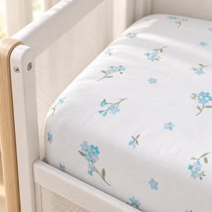 Close-up of blue forget-me-not SnuzPod fitted sheet showing cotton texture and secure fit