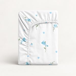 Forget-Me-Not baby fitted sheet in soft 100% cotton. Delicate blue flowers on white, handmade in the UK for cot, cot bed and crib mattresses.