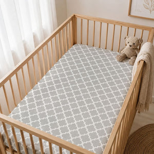 Grey and white quatrefoil cot fitted sheet styled in a neutral Scandinavian baby nursery