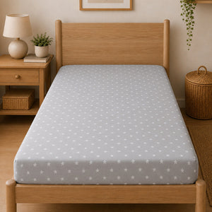 Grey and white star print single bed fitted sheet styled in natural bedroom UK