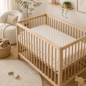 Little brown hearts muslin cot sheet styled in a neutral nursery, soft breathable baby bedding for UK cots, cot beds and cribs. Fabricco UK