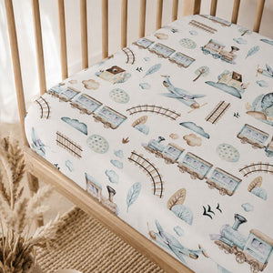 Trains and aeroplanes baby cot fitted sheet in soft blue and mint cotton styled in a Scandinavian nursery
