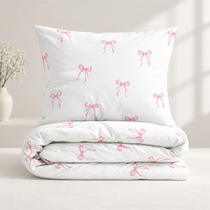 Close-up of pink bow cotton single bedding with soft ribbon print on white OEKO-TEX cotton