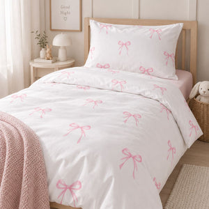 Pink bow girls single bedding set styled on a wooden single bed in a soft Scandinavian bedroom, Fabricco UK