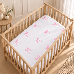 Pink bow baby cot fitted sheet handmade in the UK from 100% OEKO-TEX cotton. Fabricco Baby Shop