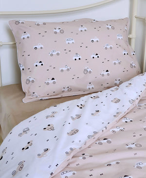 Single bed with beige boys duvet cover set featuring neutral cars and tractors print – ideal cotton bedding for a child’s bedroom.