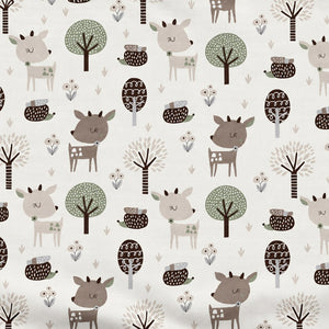 Close-up of beige and brown deer, hedgehogs, trees and berry sprigs on white cotton fabric