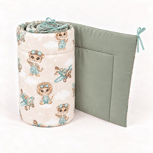 Safari Pilot cot and cot bed bumper showing animal and aeroplane print, plain sage green reverse and soft mint ties