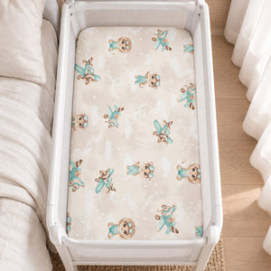 Beige and mint Safari Pilots fitted sheet on a mattress in a white SnuzPod bedside crib