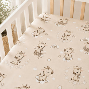 Beige giraffe baby fitted sheet in 100% cotton on a cot mattress with stars and bubbles, available in cot, cot bed and crib sizes