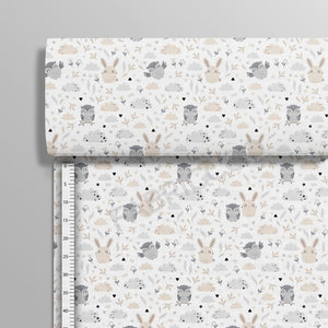 Beige Owls and Friends cotton fabric on a roll from Fabricco UK showing the upright vertical woodland animal print.