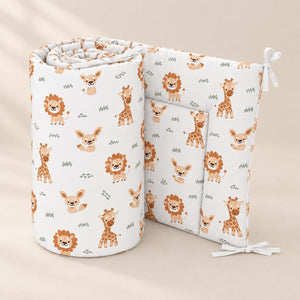 Beige safari animals cot and cot bed bumper standing partly unrolled, showing the matching animal print on both sides and white fabric ties