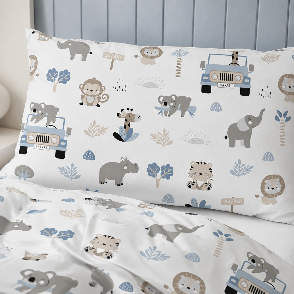 Blue safari cot and cot bed bedding set with jungle animals and safari jeeps in a wooden cot against a soft blue panelled nursery wall.