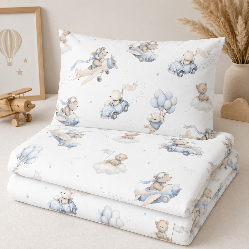 Blue teddy bear aviation cot and cot bed bedding set with aeroplanes, cars, balloons and clouds, made from 100% cotton in the UK.