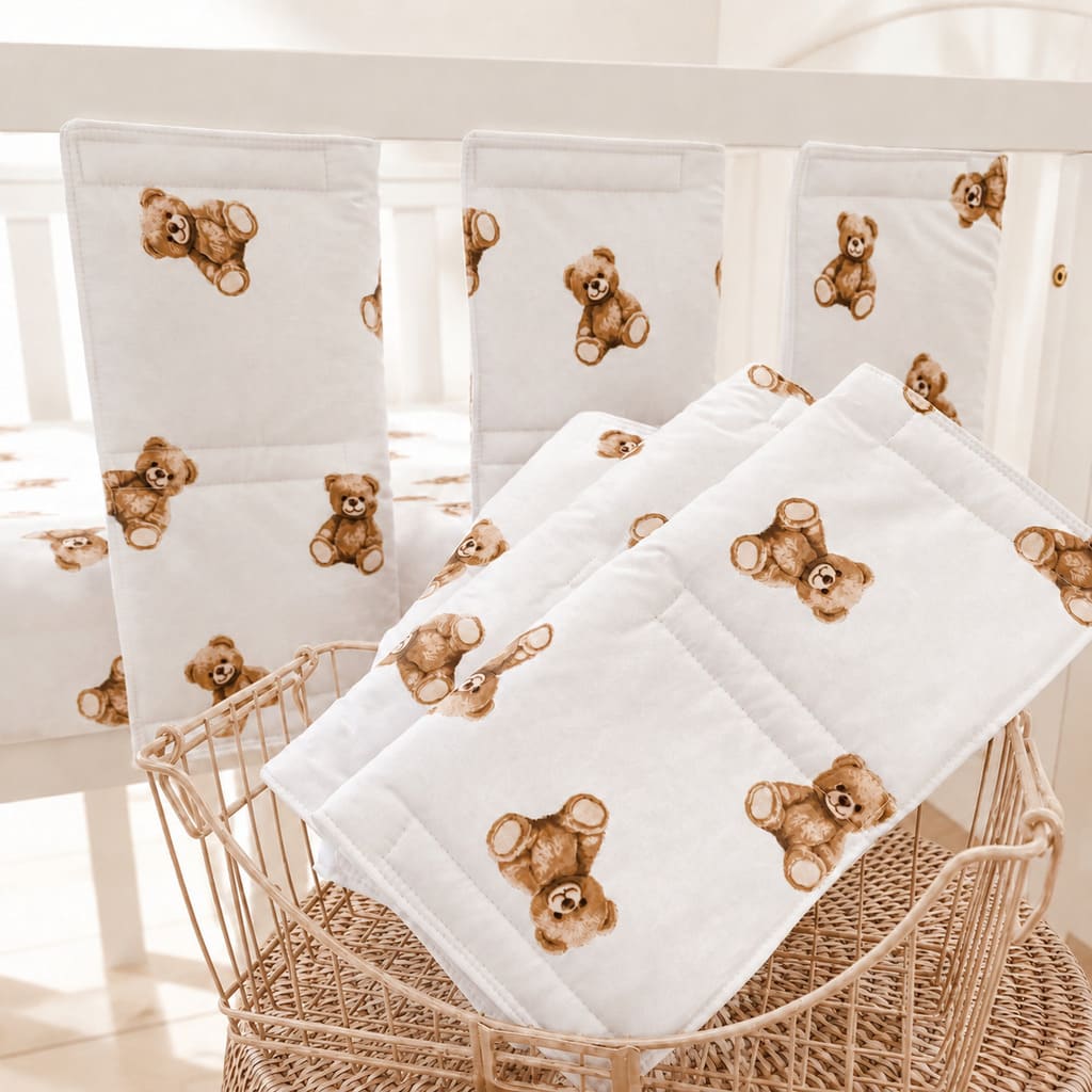 padded teddy bear cot wraps in white cotton with warm brown teddy bear print fitted around white cot rails, Fabricco UK