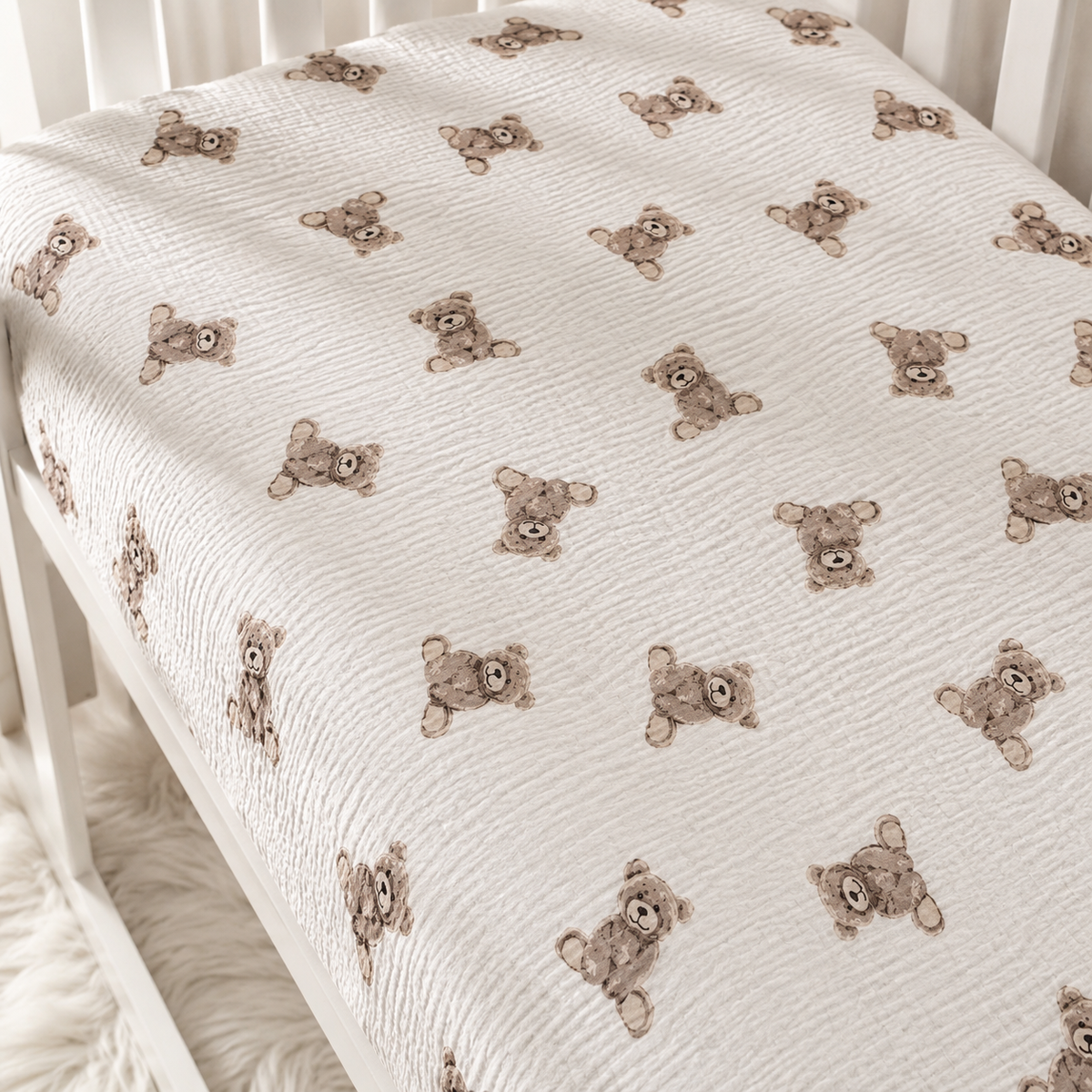 Elasticated teddy bear baby fitted sheet showing a snug fit around the cot mattress, handmade from breathable cotton muslin double gauze. UK