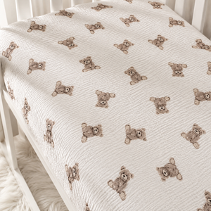 Elasticated teddy bear baby fitted sheet showing a snug fit around the cot mattress, handmade from breathable cotton muslin double gauze. UK