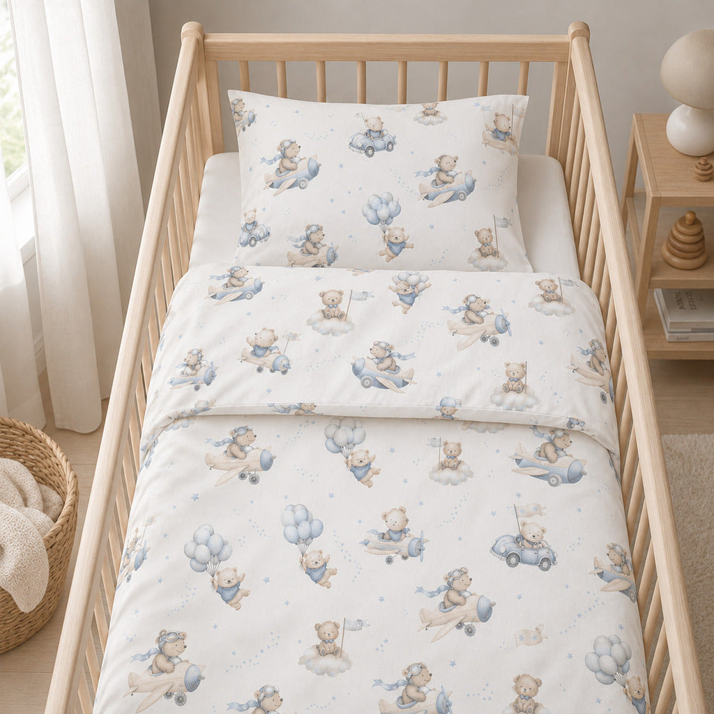Close-up of blue teddy bear aviation cot bedding with bear pilots, aeroplanes, cars, balloons and clouds on soft cotton fabric., Fabricco