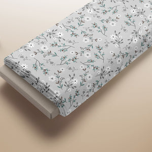 Floral cotton fabric featuring meadow flowers and soft sage leaf design for sewing and crafts