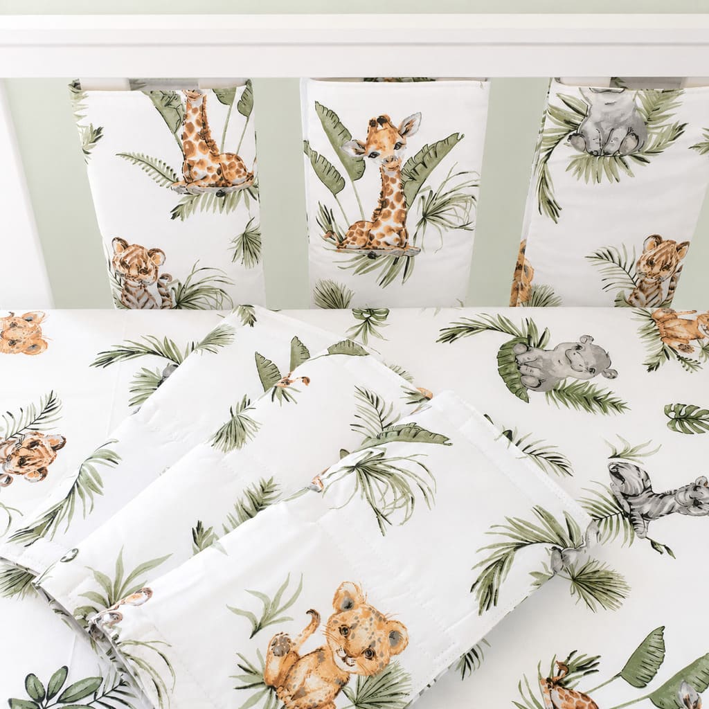 Close-up of Cute Jungle Friends padded cot wraps showing giraffe, lion and hippo print in soft neutral safari colours