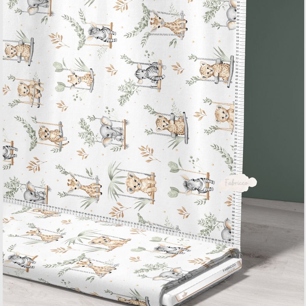 ute Safari Animals sage green cotton fabric on a roll from Fabricco UK, 160 cm wide, showing the horizontal safari print.