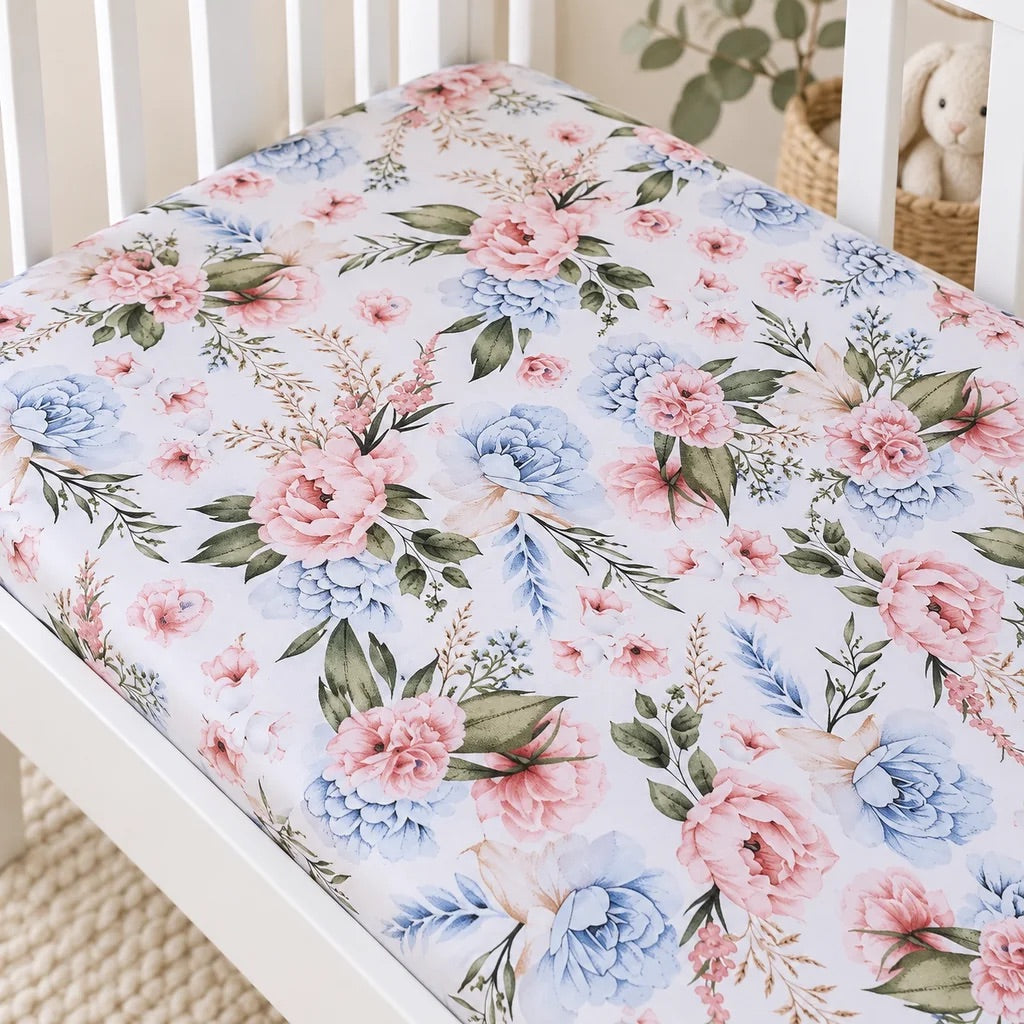 Close-up of English Garden Flowers cotton baby fitted sheet with blush pink and soft blue flowers