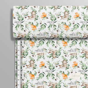 Forest Friends green cotton fabric on a roll from Fabricco UK, 160 cm wide, showing the horizontal woodland animal pattern.