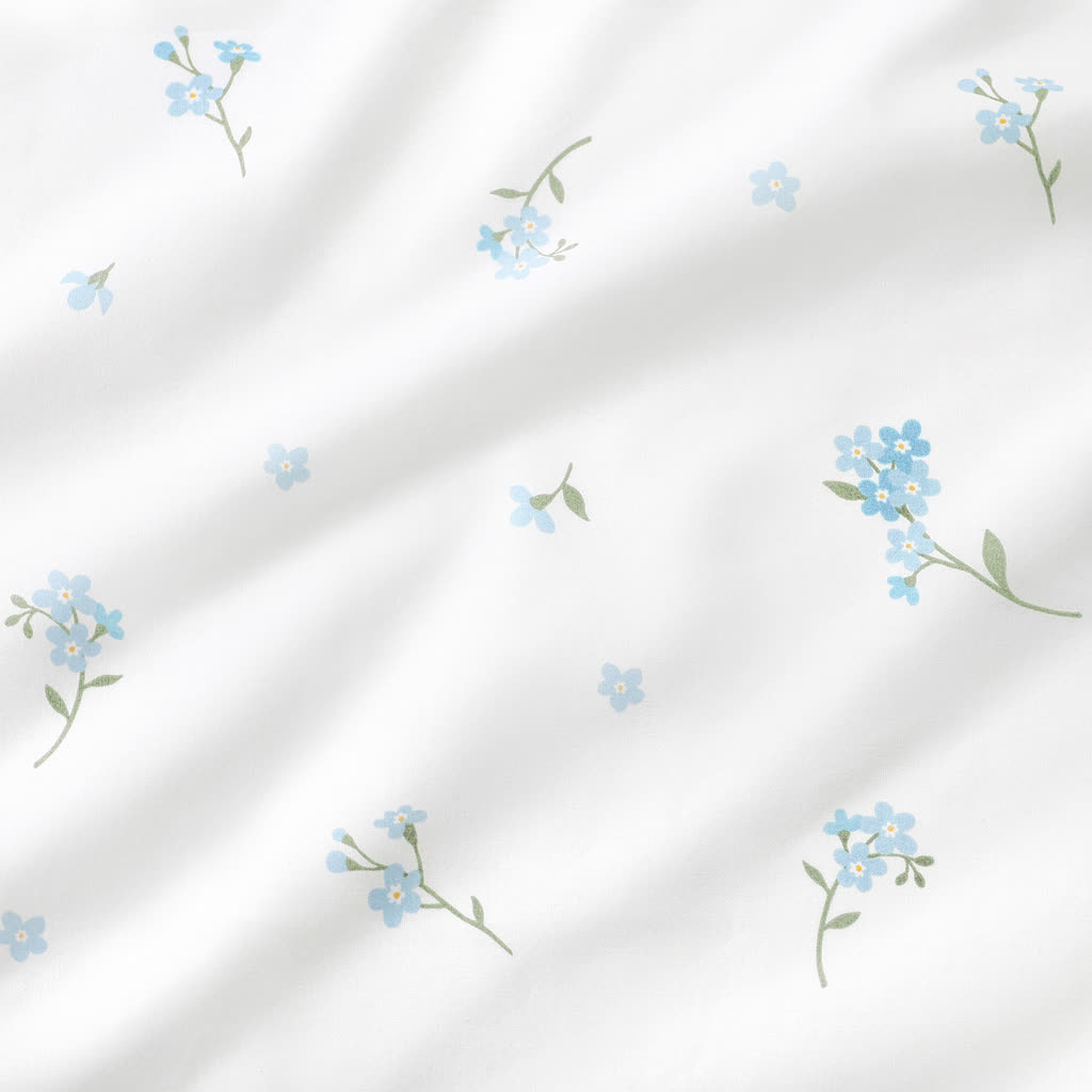 Blue forget-me-not floral 100% cotton fabric with green leaves on a white background, OEKO-TEX certified fabric by the metre UK