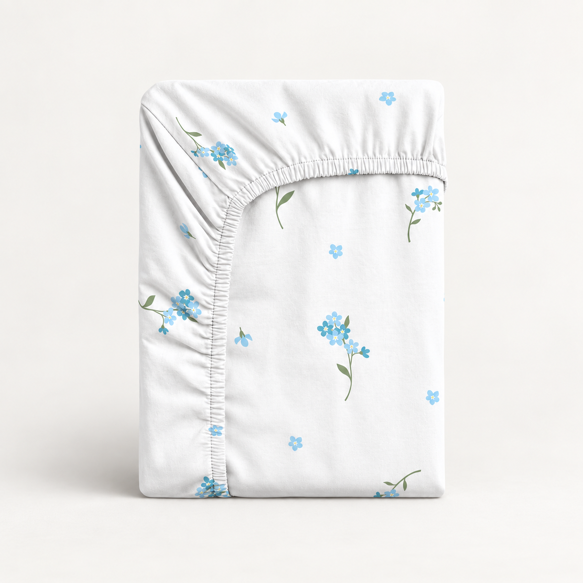 Forget-Me-Not baby fitted sheet in soft 100% cotton. Delicate blue flowers on white, handmade in the UK for cot, cot bed and crib mattresses.