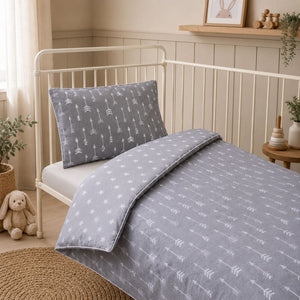 Grey arrows and stars kids single bed bedding set with reversible duvet cover and white piping in a Scandinavian bedroom