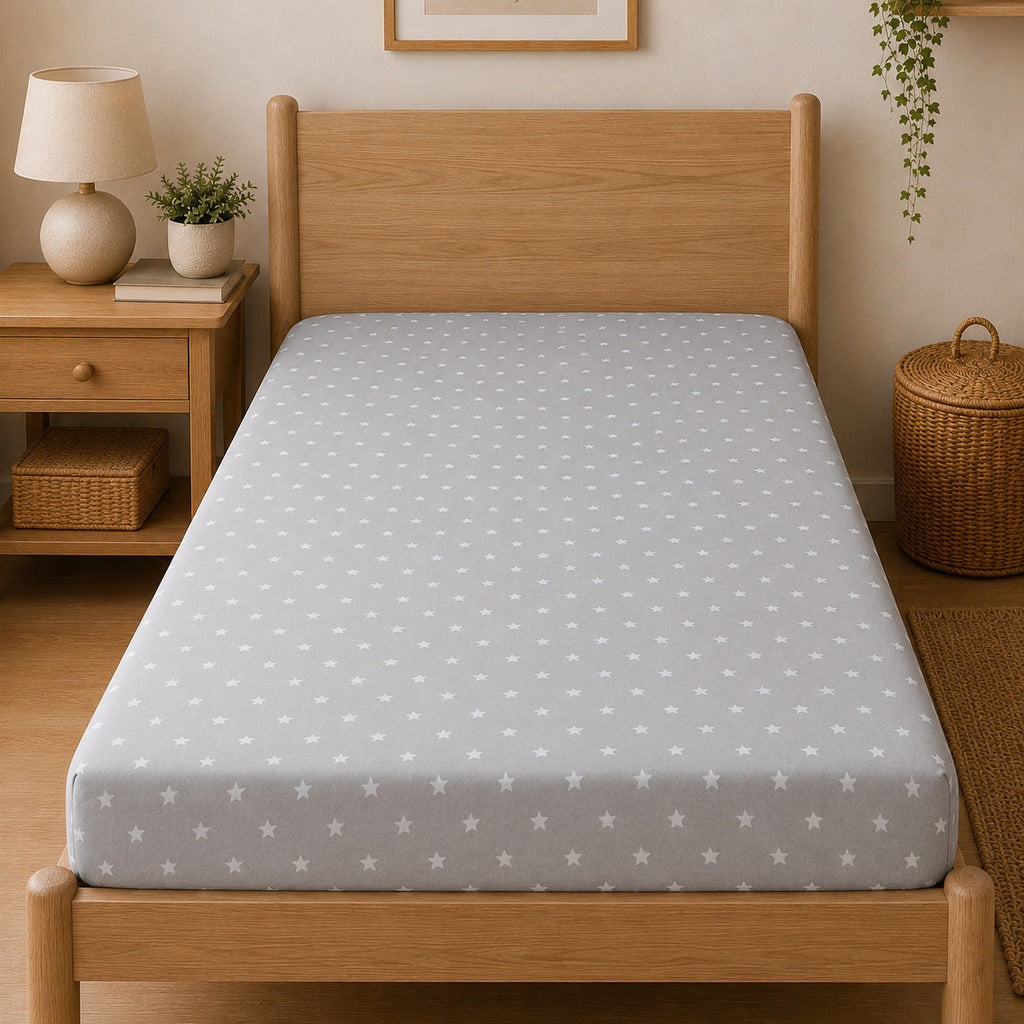 Grey and white star print single bed fitted sheet styled in natural bedroom UK