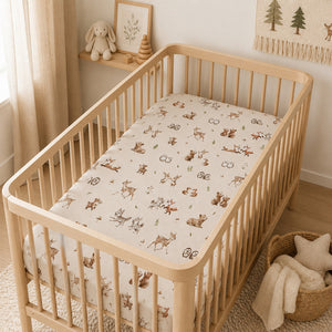 Woodland animals baby fitted sheet with deer, foxes, bears, rabbits and owls on soft cotton cot bed sheet in white nursery cot, Fabricco baby shop uk