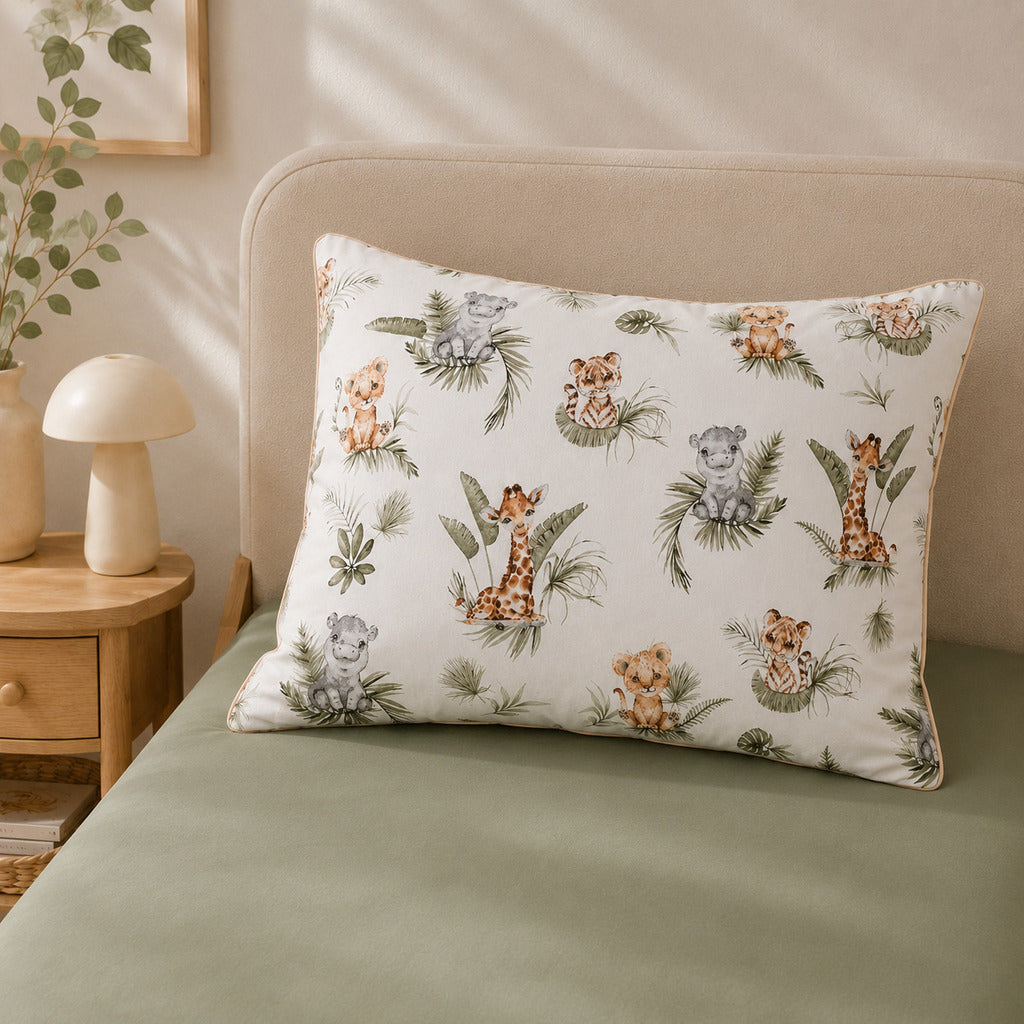 Close-up of beige safari animal cotton bedding with lions, giraffes, zebras and delicate piping.