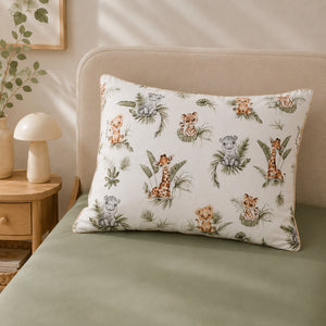 Close-up of beige safari animal cotton bedding with lions, giraffes, zebras and delicate piping.