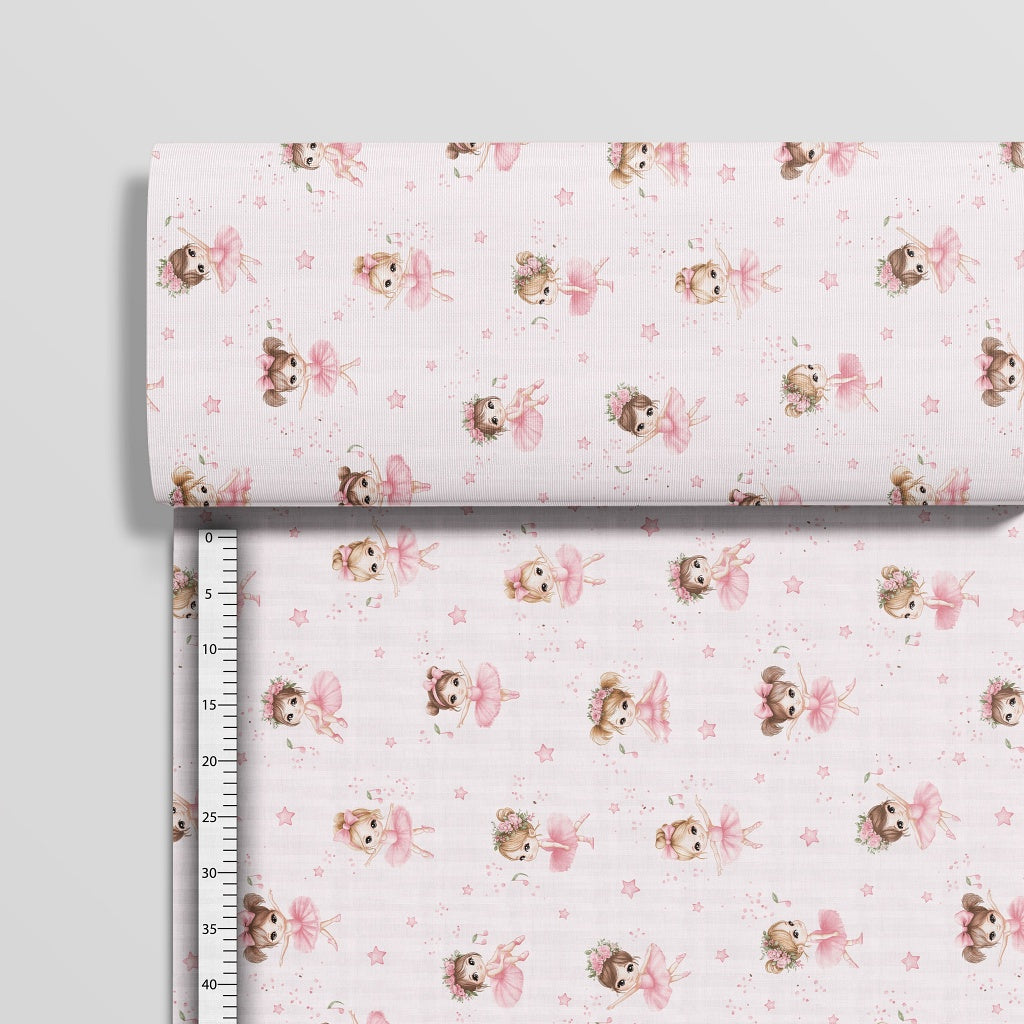 Pink ballet dancer cotton fabric on a roll from Fabricco UK showing the horizontal ballerina pattern across the fabric width.