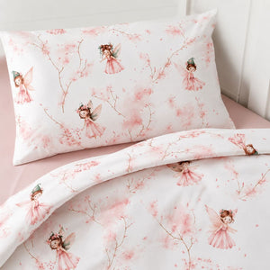 Close-up of Little Fairy baby bedding showing pink watercolour fairies, blossom branches and soft cotton fabric