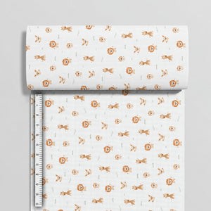 Safari animal cotton fabric beside a centimetre ruler, showing the small motifs and horizontal print direction
