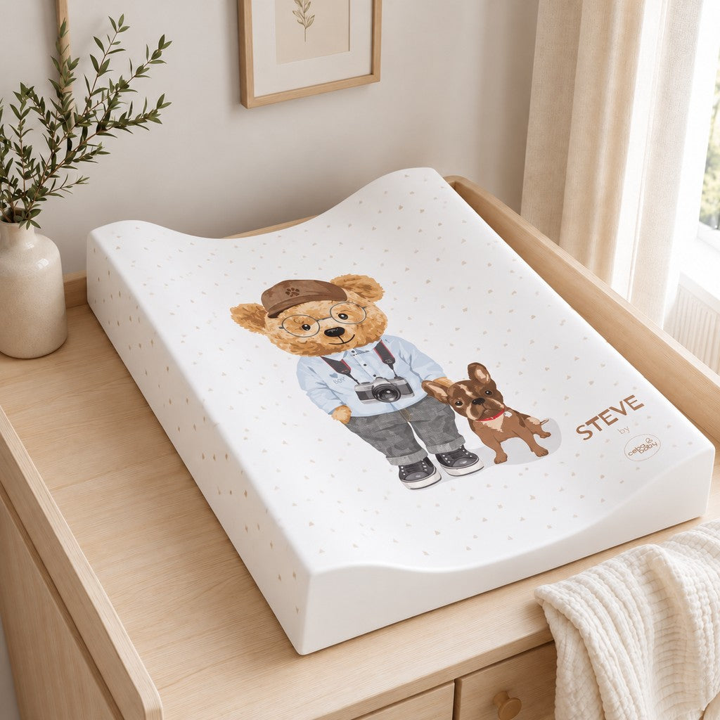 Steve teddy bear anti-roll baby changing mat with raised sides on a light oak nursery dresser
