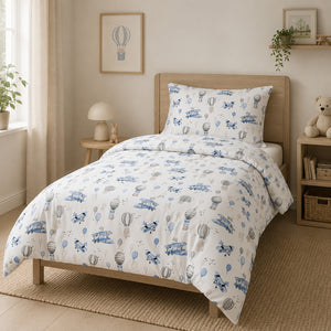 Close-up of blue and white children’s bedding featuring hot air balloons, aeroplanes and playful animal friends.