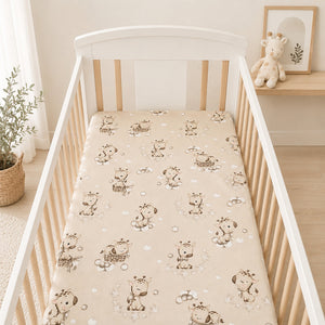 Neutral beige giraffe cot fitted sheet styled in a light Scandinavian nursery with natural wood cot