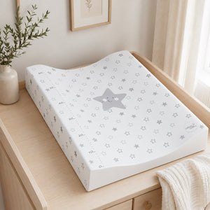 Grey star anti-roll baby changing mat with raised sides on a light oak changing unit in a neutral nursery.