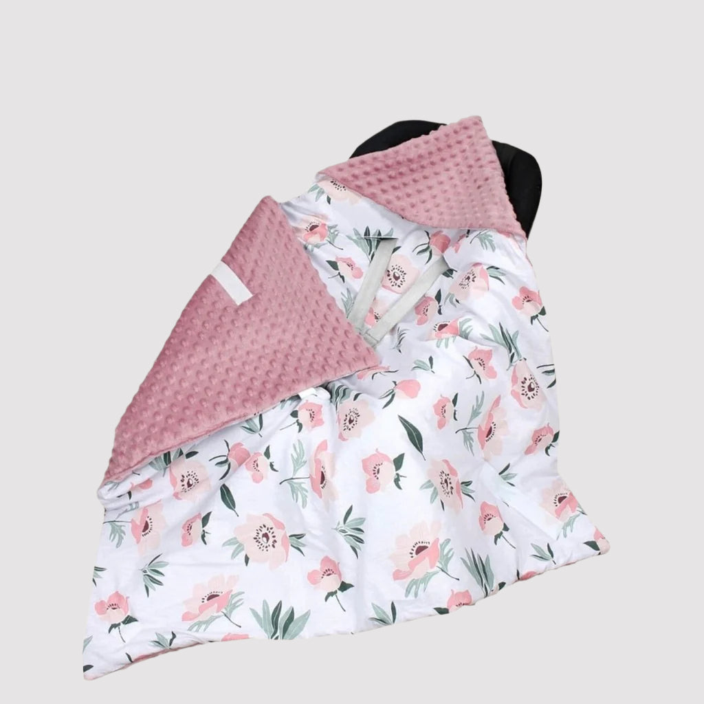 Reversible baby car seat blanket with pink floral cotton and dusty pink dimple plush fabric.
