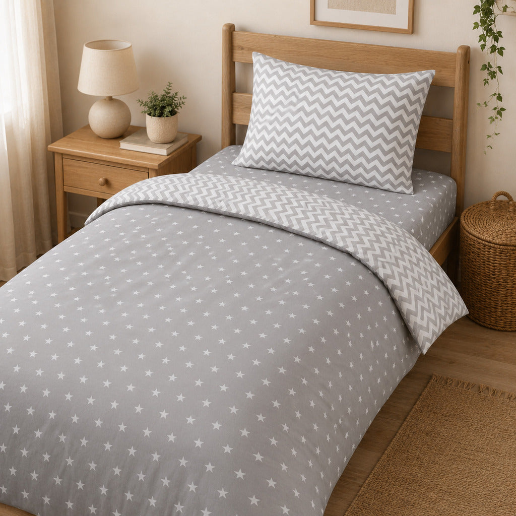 Reversible single duvet cover set with grey stars and chevron print in natural bedroom. UK Fabricco kids bedding shop
