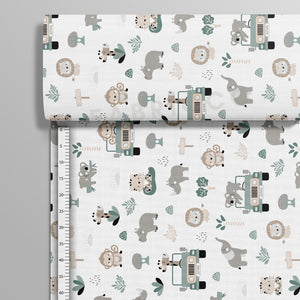 Safari Adventure sage green cotton fabric on a roll showing the horizontal jungle pattern. Fabricco UK
