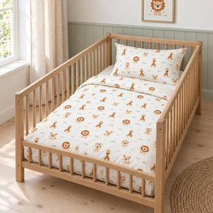 Safari animal cot bedding set in beige, brown and green, styled in an oak cot with muted green wall panelling and linen curtains.
